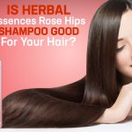 Bottle of Herbal Essences Rose Hips Shampoo placed on a bathroom counter with roses and natural ingredients, highlighting its floral and herbal formula for hair care.