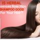 Bottle of Herbal Essences Rose Hips Shampoo placed on a bathroom counter with roses and natural ingredients, highlighting its floral and herbal formula for hair care.